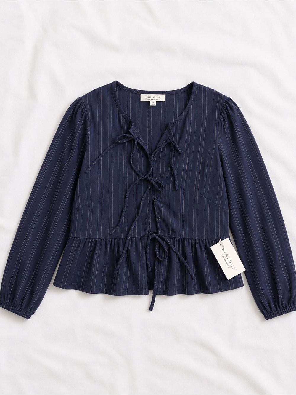 It runs small fits like M/L. Kirious Navy Pinstripe Tie-Front Peplum Blouse